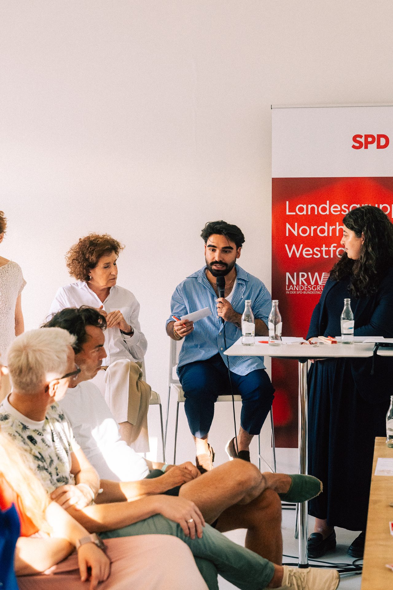 Mann spricht mit einem Mikrofon bei einer Podiumsdiskussion der SPD